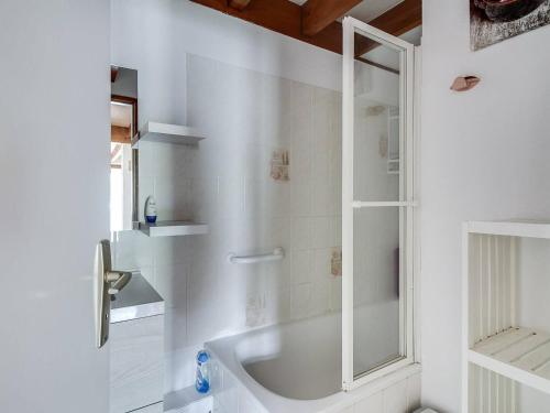 a white bathroom with a tub and a shower at Appartement Cauterets, 3 pièces, 6 personnes - FR-1-401-52 in Cauterets