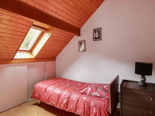 a bedroom with a bed and a window in a attic at Appartement Cauterets, 3 pièces, 6 personnes - FR-1-401-52 in Cauterets