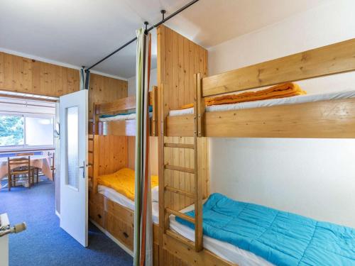 a room with bunk beds and a dining room at Studio Gourette, 1 pièce, 6 personnes - FR-1-400-63 in Gourette