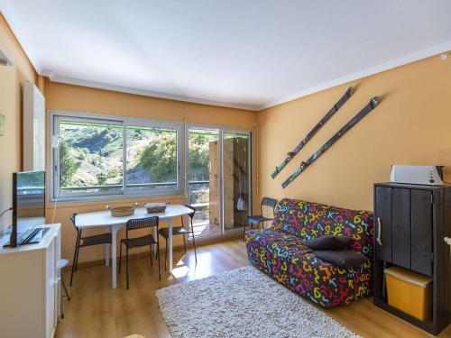 a living room with a couch and a table at Studio cabine 4 personnes, proche des pistes à Gourette - FR-1-400-65 in Gourette