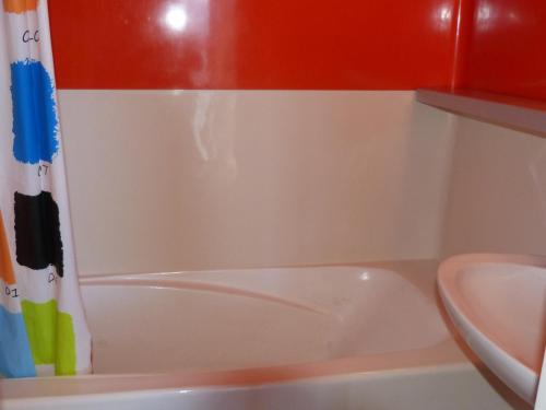 une salle de bain avec une baignoire blanche et un lavabo dans l'établissement Appartement Duplex 52m², 7 pers, proche pistes/commerces, animaux admis, parking, Wi-Fi - FR-1-411-195, à Arc 1800