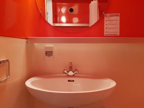 a white sink in a bathroom with a mirror at Studio Les Arcs 2000, 1 pièce, 5 personnes - FR-1-411-350 in Arc 2000