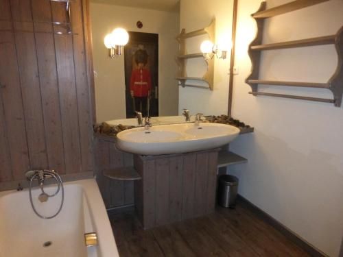 a bathroom with a sink and a mirror and a tub at Studio Méribel, 1 pièce, 4 personnes - FR-1-411-435 in Les Allues