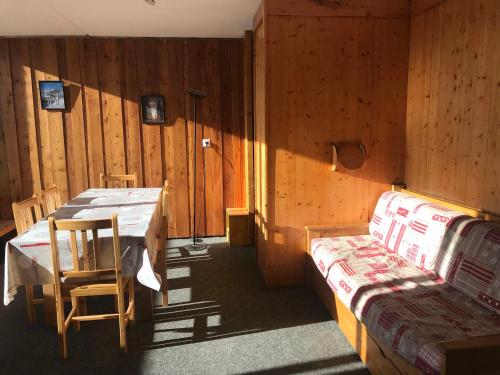 Cette chambre comprend une table et un lit. dans l'établissement Appartement 3 pièces pour 7 personnes à Arc 1600, ski aux pieds, proche commerces, WiFi - FR-1-411-325, à Arc 1600