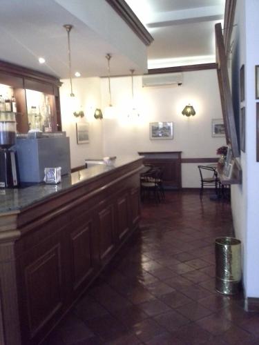 a bar in a restaurant with a table and chairs at Albergo Italia di Nardi Renzo & C Snc in Poggibonsi