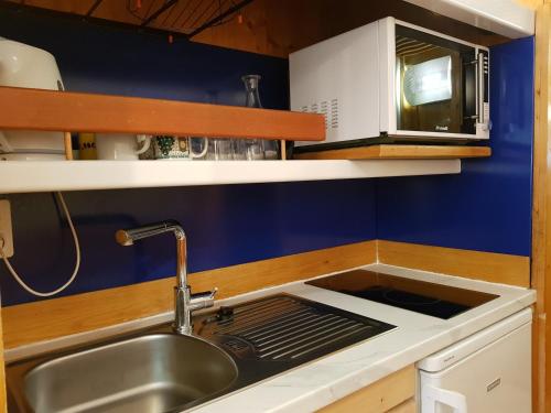 a kitchen with a sink and a stove top oven at Studio Les Arcs 1600, 1 pièce, 3 personnes - FR-1-411-413 in Arc 1600