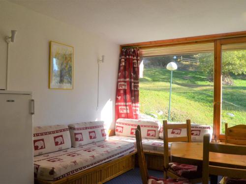 a room with a table and chairs and a window at Studio Les Arcs 1800, 1 pièce, 5 personnes - FR-1-411-470 in Arc 1800