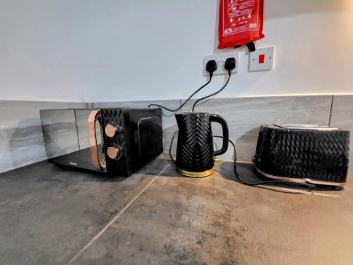 a couple of black appliances sitting on the floor at Easy Living Nottingham - Burns Street in Nottingham