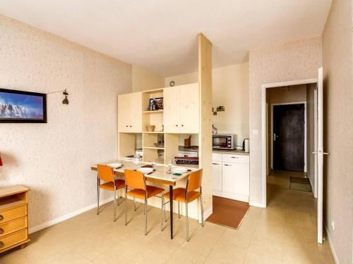 une cuisine avec une table et des chaises dans une pièce dans l'établissement Studio en centre-ville avec 2 coins nuit, cuisine équipée et proche télécabine - 5 pers. - FR-1-401-116, à Cauterets