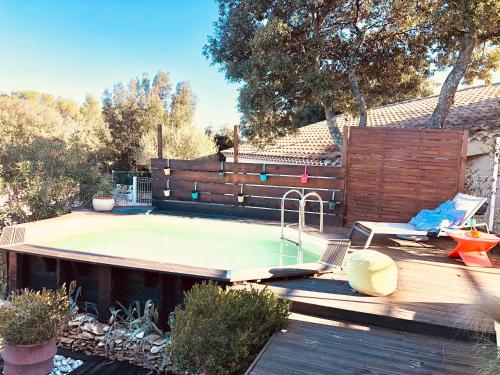 - une piscine dans un jardin avec une clôture en bois dans l'établissement L'Escapade, Magnifique Villa avec Piscine, à Collias
