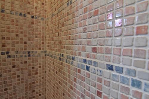 a bathroom with a brick wall and a window at Villa Very in Marina di Campo