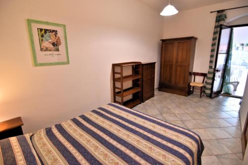 a bedroom with a bed and a dresser in it at Villa Very in Marina di Campo