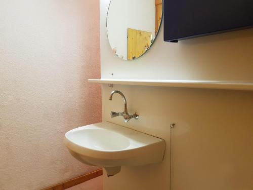 une salle de bain avec un lavabo et un miroir dans l'établissement Studio confortable à Arc 1600, ski aux pieds, proche commerces, pour 3 personnes - FR-1-411-530, à Arc 1600
