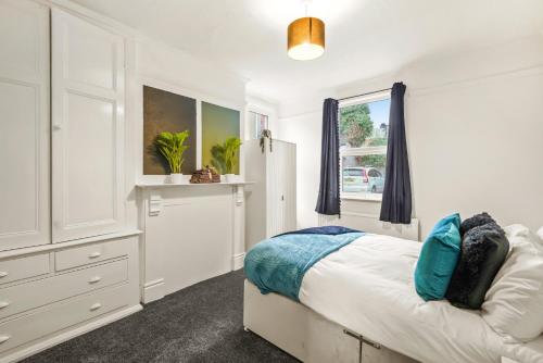 a white bedroom with a bed and a window at Stylish 4 Bed House in Yorkshire - Football Table in Pontefract