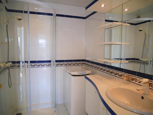 a white bathroom with a shower and a sink at Quiberon: Appartement 3 pièces avec balcon et parking près du centre - FR-1-478-37 in Quiberon