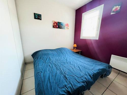 a bedroom with a blue bed and a window at Appartement T1 Bis avec Terrasse et Piscine à Cambo-les-Bains, 1 Chambre, Parking Privé - FR-1-495-4 in Cambo-les-Bains