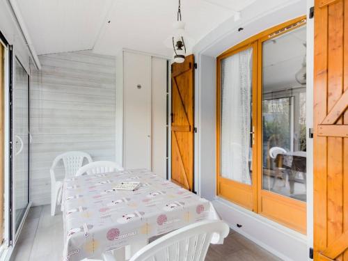 a white dining room with a table and chairs at Appartement Luz-Saint-Sauveur, 2 pièces, 4 personnes - FR-1-402-79 in Luz-Saint-Sauveur