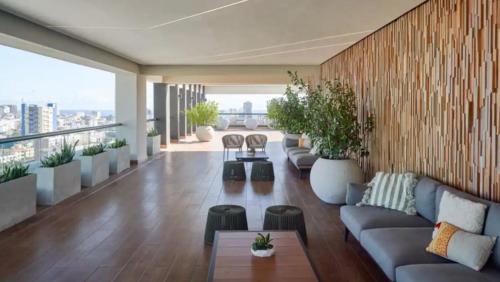 a living room with couches and potted plants at 1br Luxury Condo Jacuzzi, gym Mountains with parking lot in Los Prados