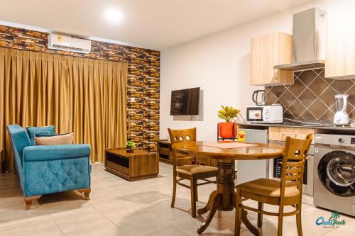 a kitchen and dining room with a table and chairs at OASIS PARK RESIDENCE in East Legon