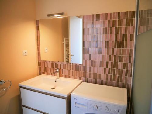 uma casa de banho com um lavatório e um espelho em Appartement Quiberon, 2 pièces, 4 personnes - FR-1-478-88 em Quiberon
