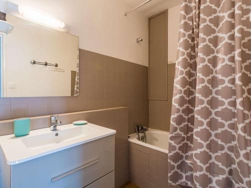 a bathroom with a sink and a shower curtain at Studio Biarritz, 1 pièce, 2 personnes - FR-1-3-487 in Biarritz