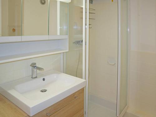 a bathroom with a white sink and a shower at Studio Les Orres, 1 pièce, 4 personnes - FR-1-322-387 in Les Orres