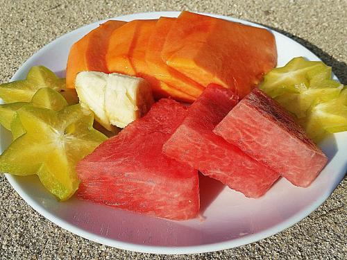 a plate of fruits and vegetables on a table at Hotel Playa Bonita Tayrona in Buritaca