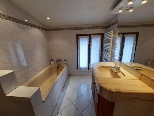 a bathroom with a tub and a sink and a tub and a bath tub at A 200 mètres du château : maison de ville in Carcassonne