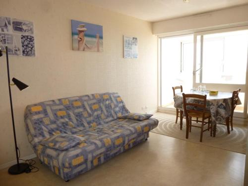 un salon avec un canapé et une table dans l'établissement Appartement 2 pièces, balcon, parking, animaux admis, plage à pied - FR-1-224C-58, à Saint-Hilaire-de-Riez