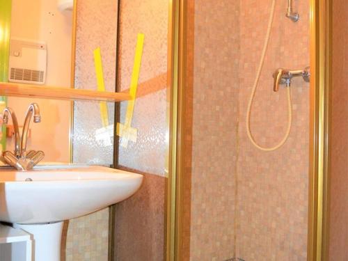 a bathroom with a shower with a sink and a toilet at Appartement calme centre station avec parking - FR-1-593-41 in Les Angles