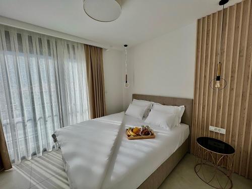 a bedroom with a bed with a tray of food on it at Solaris Lux Apartments in Kotor
