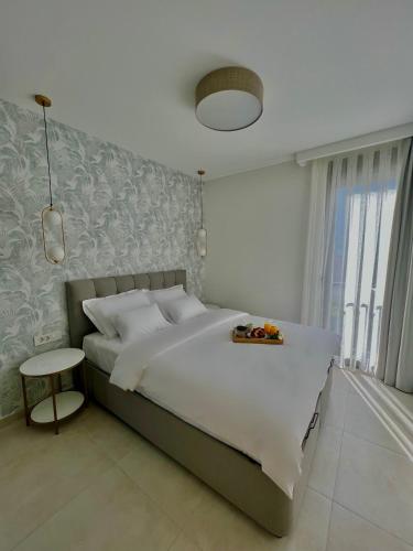 a bedroom with a large bed and a table at Solaris Lux Apartments in Kotor