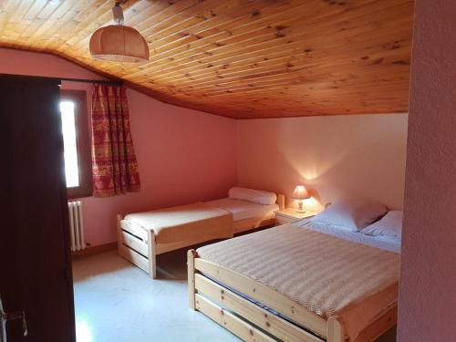 a bedroom with two beds and a wooden ceiling at Chalet Arêches-Beaufort, 6 pièces, 12 personnes - FR-1-342-198 in Arêches