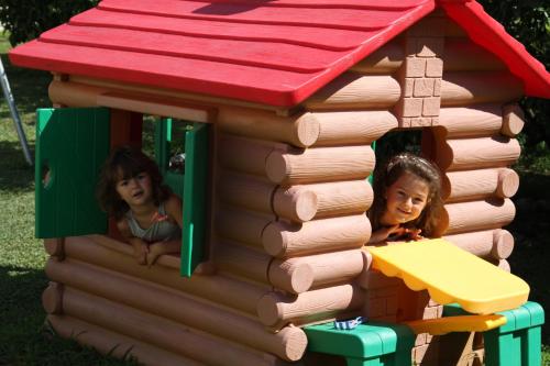 two girls are playing in a toy house at Guest House Pasha in Ulcinj