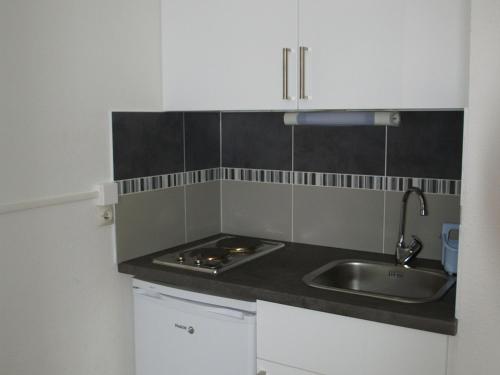 a kitchen with a sink and a counter top at Appartement Les Adrets-Prapoutel, 1 pièce, 3 personnes - FR-1-557-10 in Les Adrets