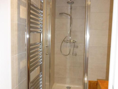 a shower with a glass door in a bathroom at Appartement Méribel, 3 pièces, 6 personnes - FR-1-411-661 in Les Allues