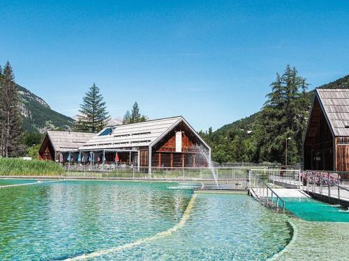 une grande piscine d'eau en face d'un bâtiment dans l'établissement Maison La Salle-les-Alpes, 4 pièces, 10 personnes - FR-1-330F-3, à La Salle Les Alpes