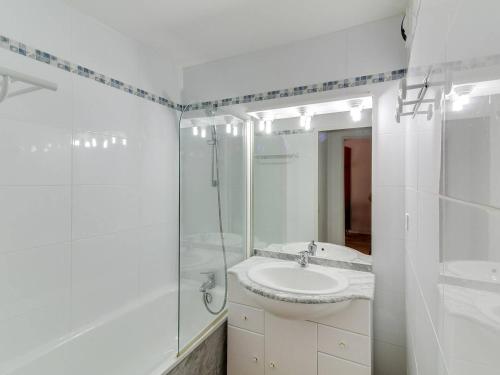 une salle de bain blanche avec un lavabo et une douche dans l'établissement Duplex au calme 7 couchages, balcon sud, parking, piscine couverte, fitness, proche pistes et centre - FR-1-404-244, à La Mongie