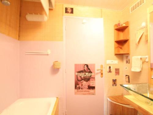 a bathroom with a white door with a poster on it at Appartement Briançon, 1 pièce, 4 personnes - FR-1-330C-3 in Briançon