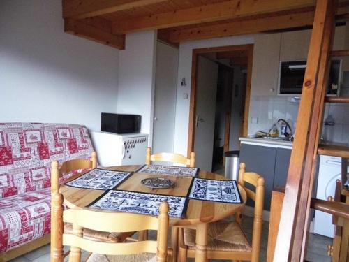 une table et des chaises dans une cuisine avec une table et un canapé dans l'établissement Location 2 pièces cabine mezzanine à Saint-Jean-d'Aulps, pied de pistes, parking, animaux admis - FR-1-573-29, à Saint-Jean-dʼAulps