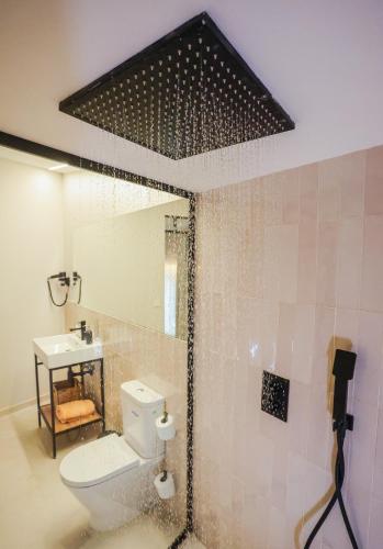 a bathroom with a toilet and a sink and a mirror at Mythic Valencia in Valencia