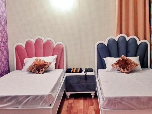 Hotel Rose One Lahoreにあるベッド