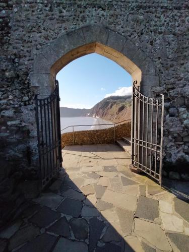an archway in a castle with a view of the water at The Groveside Guest House in Sidmouth