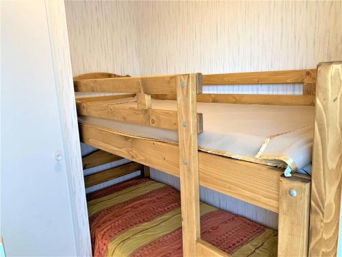 a couple of wooden bunk beds in a room at Studio cabine cosy à Quiberon avec vue mer et garage - FR-1-478-184 in Quiberon