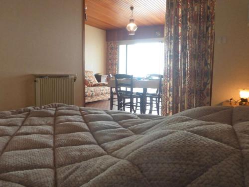 a bedroom with a bed and a dining room at Appartement spacieux 1er étage avec balcon, vue mer, double garage à Saint-Gilles-Croix-de-Vie - FR-1-224-775 in Saint-Gilles-Croix-de-Vie