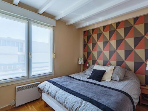 a bedroom with a bed and a large window at Appartement Saint-Jean-de-Luz, 4 pièces, 6 personnes - FR-1-4-590 in Saint-Jean-de-Luz