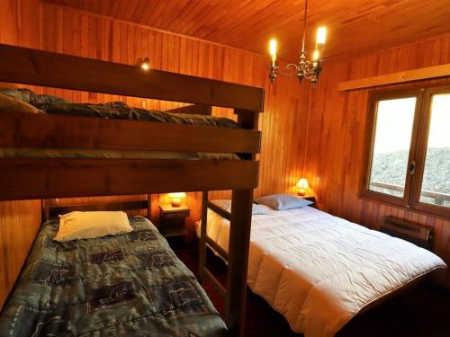 a bedroom with two bunk beds and a window at Chalet pour 6-8 pers. avec cheminée, plein sud et garage à 5 min du centre - FR-1-342-234 in Beaufort