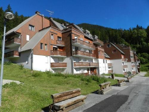 un bâtiment sur une colline avec des bancs devant lui dans l'établissement Studio cosy au pied des pistes, près des remontées et commerces - FR-1-557A-34, à La Ferrière