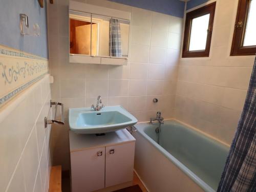 a bathroom with a sink and a bath tub at Chalet pour 6-8 pers. avec cheminée, plein sud et garage à 5 min du centre - FR-1-342-234 in Beaufort