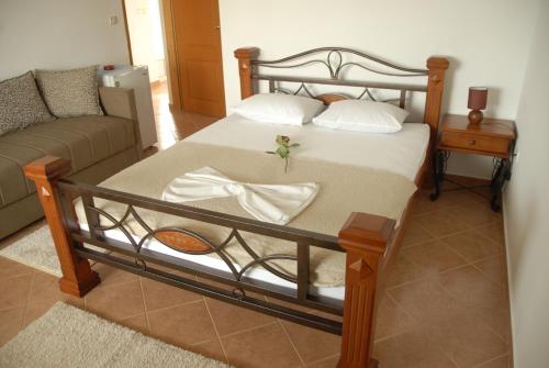 a bedroom with a bed and a couch at Guest House Pasha in Ulcinj